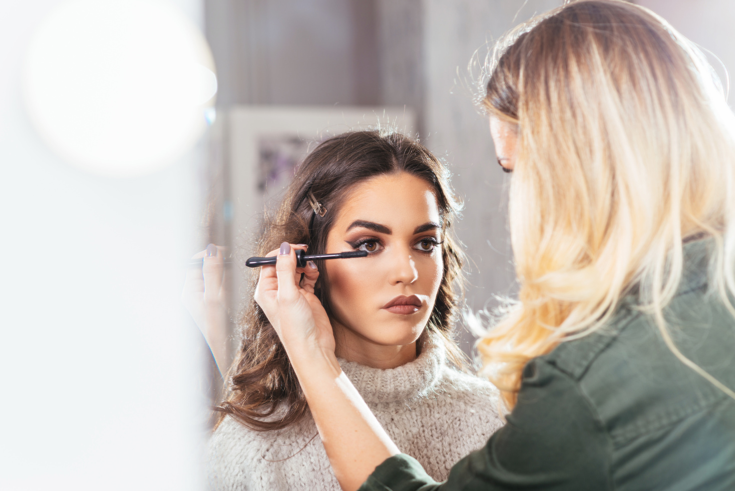 Make up artist applying make up on model